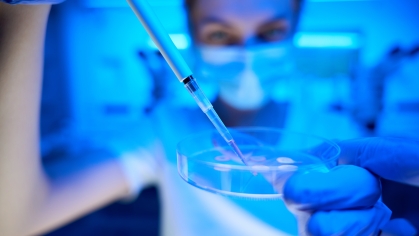 Woman manipulates biomaterial in a modern scientific laboratory