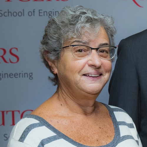 head shot of women with short grey hair wearing glasses and a striped white and blue shirt