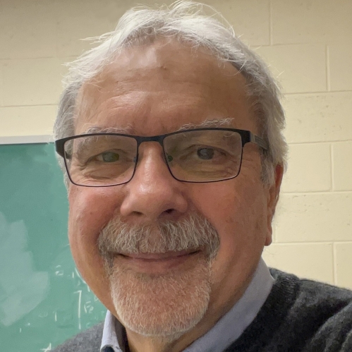 Male with short grey hair, moustache, and beard with eyeglasses.
