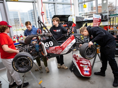 Rutgers Formula Race Car team working in the garage on the race car. 
