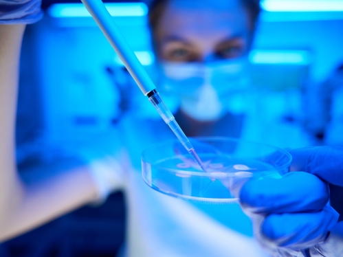 Woman manipulates biomaterial in a modern scientific laboratory